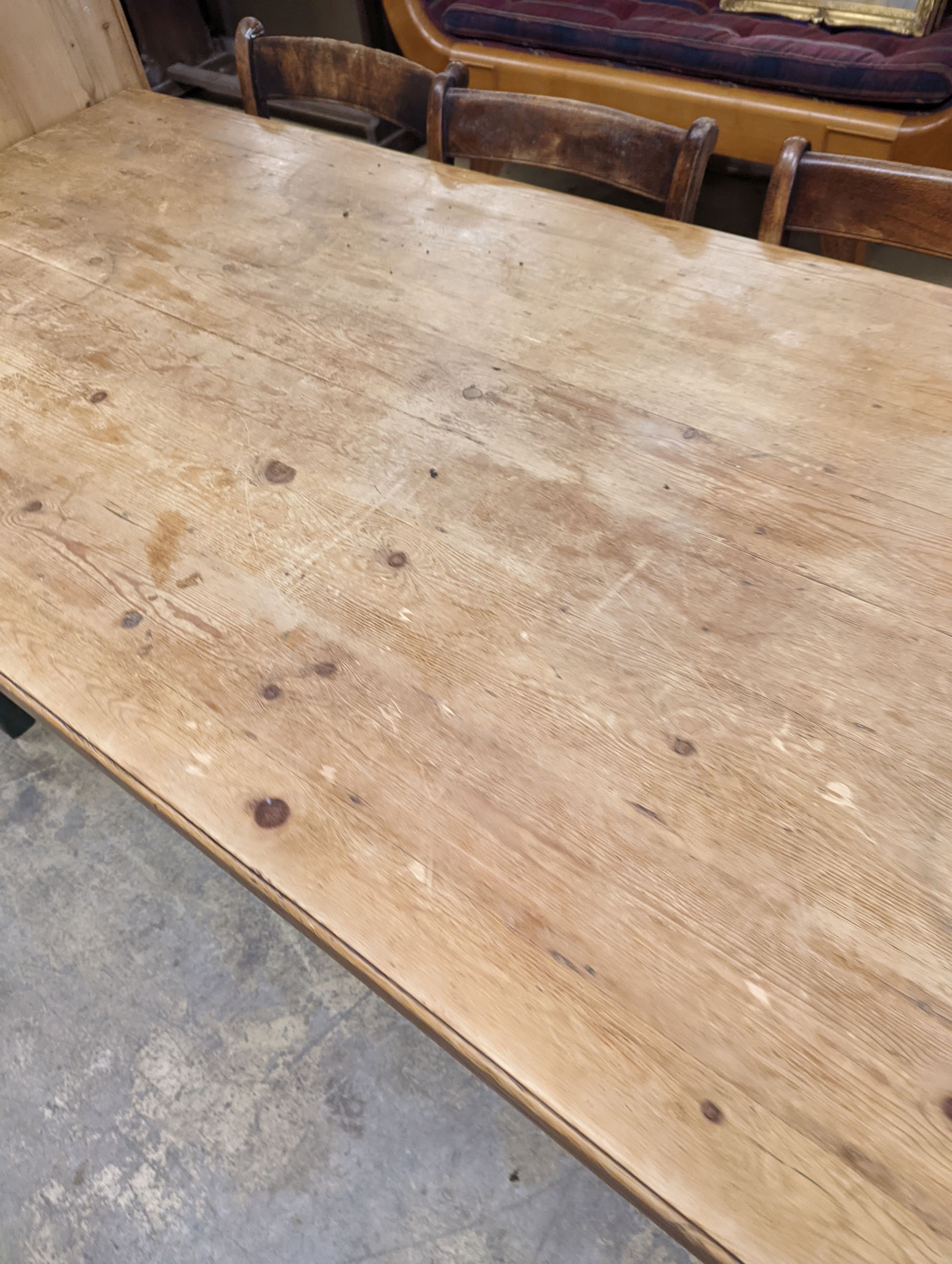 A rustic farmhouse pine kitchen table with painted legs, length 192cm, depth 85cm, height 76cm